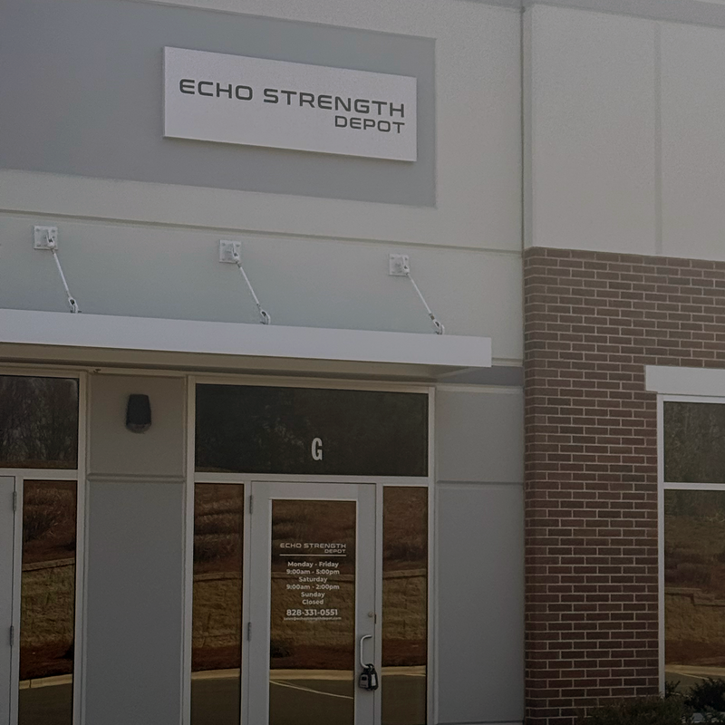 Building exterior with 'Echo Strength Depot' sign on a clear day